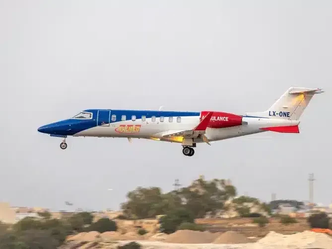 Air ambulance jet coming in to land on a clear day