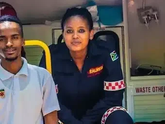 Two Ralmed crew members seated in the back of an ambulance