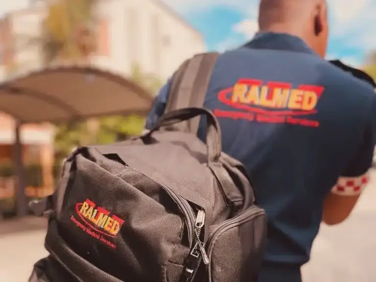 A Ralmed paramedic carrying a medical backpack
