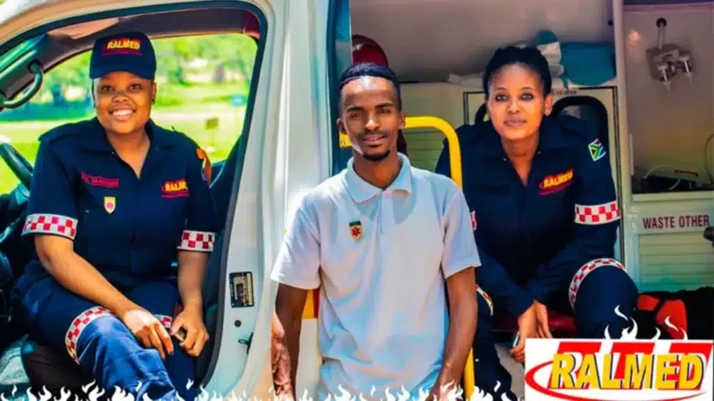 Three Ralmed crew members sitting at the open door of a Ralmed ambulance